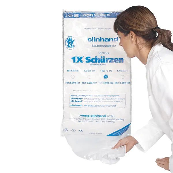 A woman in a white coat pulls a Clinhand women's disposable apron, 120 cm, from an Altruan package labeled "50 pieces" disposable aprons with product information in blue and black on the front.