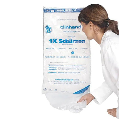 A woman in a white coat pulls a Clinhand women's disposable apron, 120 cm, from an Altruan package labeled "50 pieces" disposable aprons with product information in blue and black on the front.
