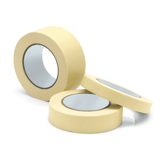 En la imagen se muestran tres rollos de cinta de enmascaraje para pintores «Nölle Profi Brush», de la empresa Nölle Profi Brush Bürsten- & Pinseltechnik e.K., en color beige sobre fondo blanco —dos en posición vertical y uno en horizontal—, con los núcleos de cartón visibles, ideales para bordes de pintura precisos y trabajos profesionales.