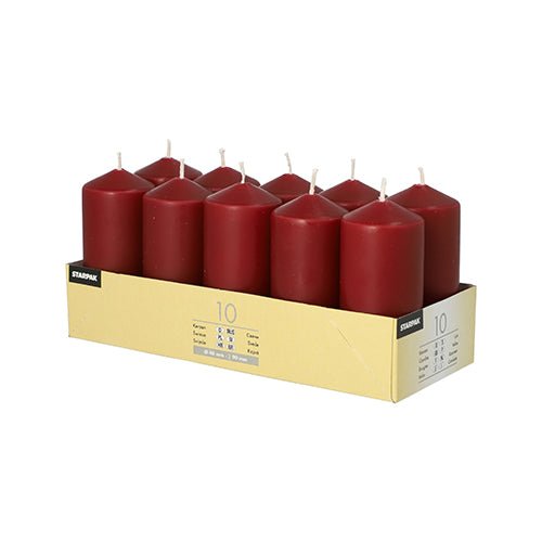 A cardboard tray holds 10 Starpak pillar candles (Ø 40 mm, 90 mm) in two rows. Each red candle has a white wick—ideal for weddings or celebrations. The tray features a label on the side with product details.