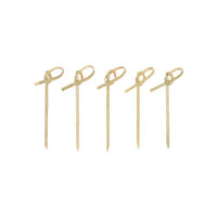 Forty PAPSTAR 40 “pure” finger food picks from the PAPSTAR Bamboo skewers with pointed ends and looped knots stand neatly and evenly upright on a simple white surface, making them ideal for serving finger food.