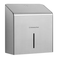 The Kimberly-Clark Professional™ Mini Jumbo stainless steel toilet paper dispenser features a slanted top and a vertical viewing window set against a plain white background. Brand: Kimberly-Clark GmbH.