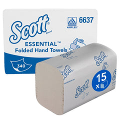 A box of Scott® Essential™ Interfold towels (white, small) from Kimberly-Clark GmbH contains 15 packs of 340 sheets each, stacked next to the box bearing the Scott logo for hygienic hand drying.