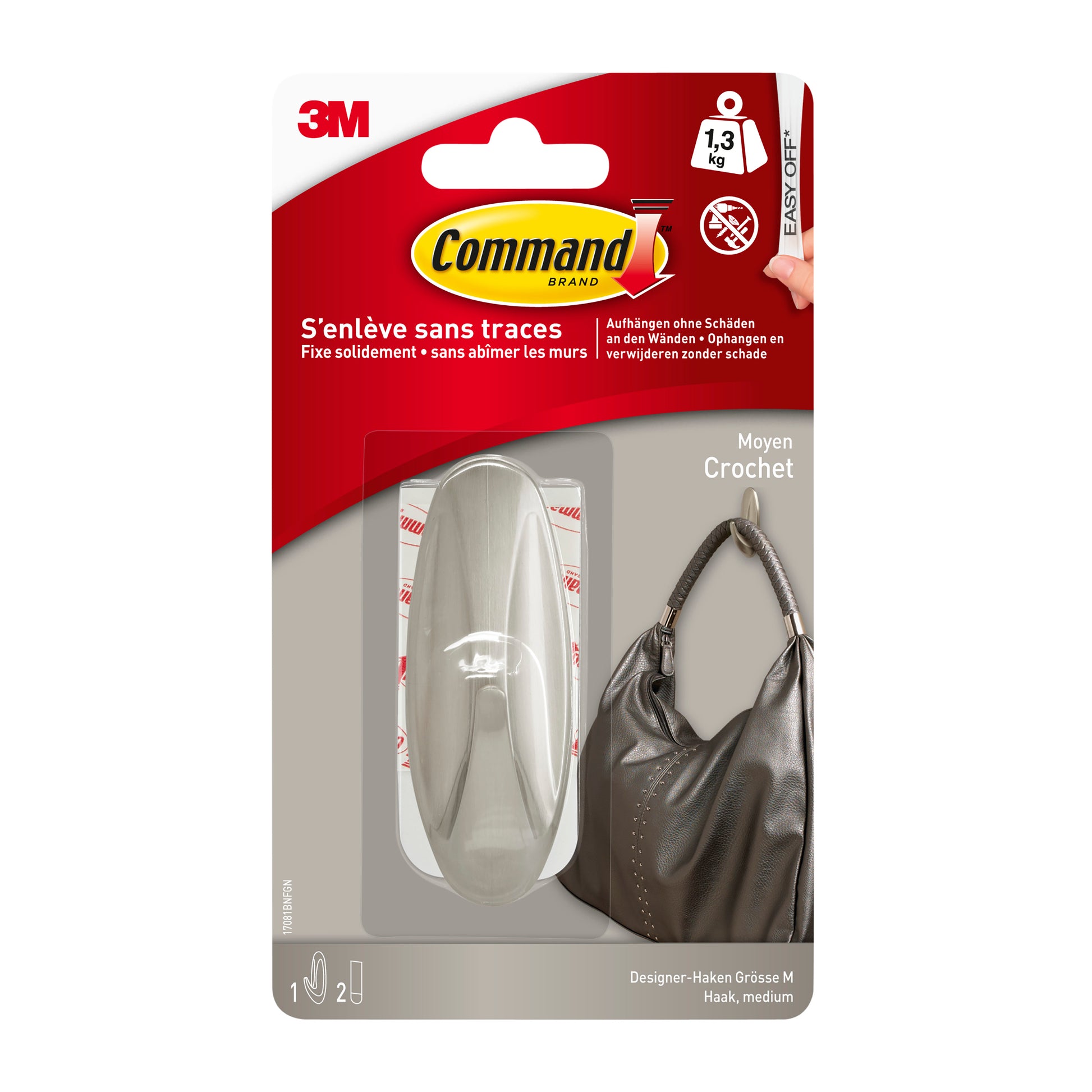 Eine Verpackung des Command™ Medium Designer-Hakens in Metall-Look (17081BN) von 3M Deutschland GmbH zeigt einen stabilen Haken, der eine Handtasche hält. Laut Verpackung hält er bis zu 1,3 kg und lässt sich sauber entfernen, ohne Spuren zu hinterlassen.