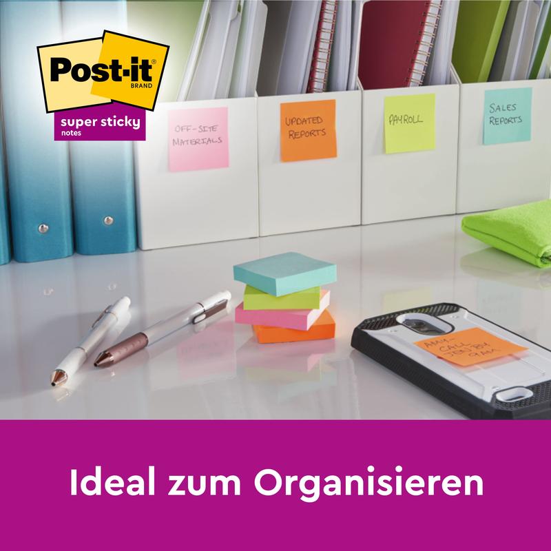 A desk with folders labeled with colorful Post-it® Super Sticky Notes Cubes in Yellow (76 x 76 mm) by 3M Deutschland GmbH, pens, highlighters, and a smartphone on a notepad. Text: "Ideal for organizing.
