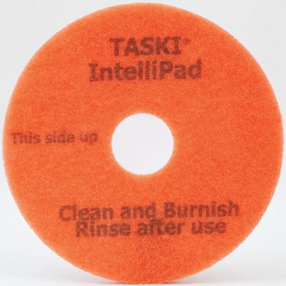 Das TASKI Intellipad Kombiniertes Reinigungs- und Polierpad für Unterhaltsreinigung von Diversey Deutschland GmbH & Co. OHG reinigt und poliert Böden effektiv - mit Markierung "This side up, Clean and Burnish, Rinse after use" und mittlerer Lochung.