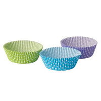 Three PAPSTAR Baking cups, cupcake liners (Ø 5 cm, 2.5 cm) from the PAPSTAR GmbH logos in green, blue, and purple with white dots are arranged on a white background—perfect for baking cupcakes or muffins.