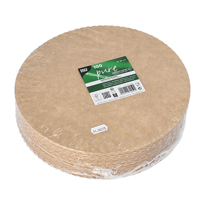 A stack of round, brown, biodegradable cardboard plates from PAPSTAR GmbH with the inscription "PAPSTAR 100 cake boards, cardboard 'pure' round" is packed in clear foil and provided with a green-white label with the inscription "Product information and gastronomy quality".