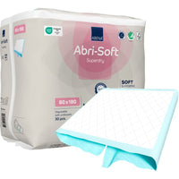 One package of Abena Re-Seller GmbH’s Abri-Soft Superdry disposable pads, 80x180 cm, contains 30 disposable pads. One pad is partially unfolded at the front. The packaging highlights the product’s key features—ideal for incontinence care.