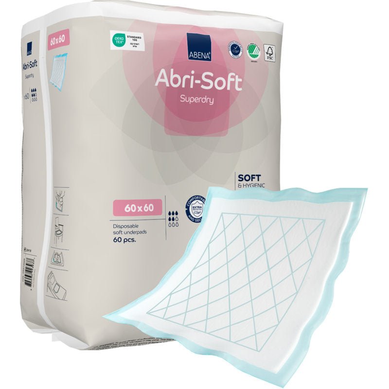 Shown is a package labeled "Disposable Pad, Abri-Soft Superdry, Blue" from Abena Re-Seller GmbH (60 x 60 cm, 60 pieces). An incontinence pad with a blue edge and grid pattern lies outside the package.