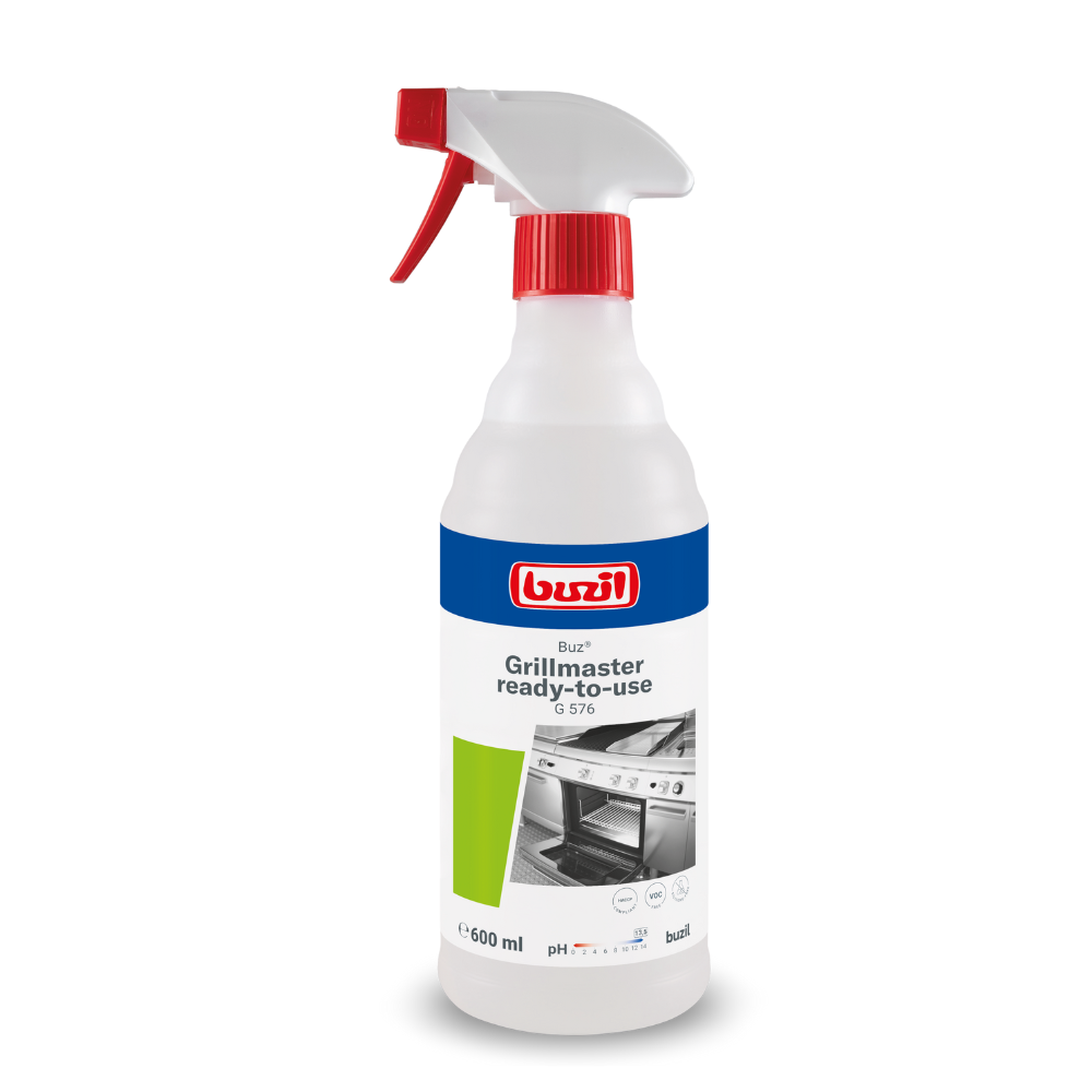 A 600 ml spray bottle with Buzil Buz® Grillmaster ready-to-use G 576, designed by BUZIL-WERK Wagner GmbH & Co. KG, is ideal for professional kitchen cleaning. The label has a white background with blue and red accents and shows an image of an oven grill, while the white cap contains a red trigger.