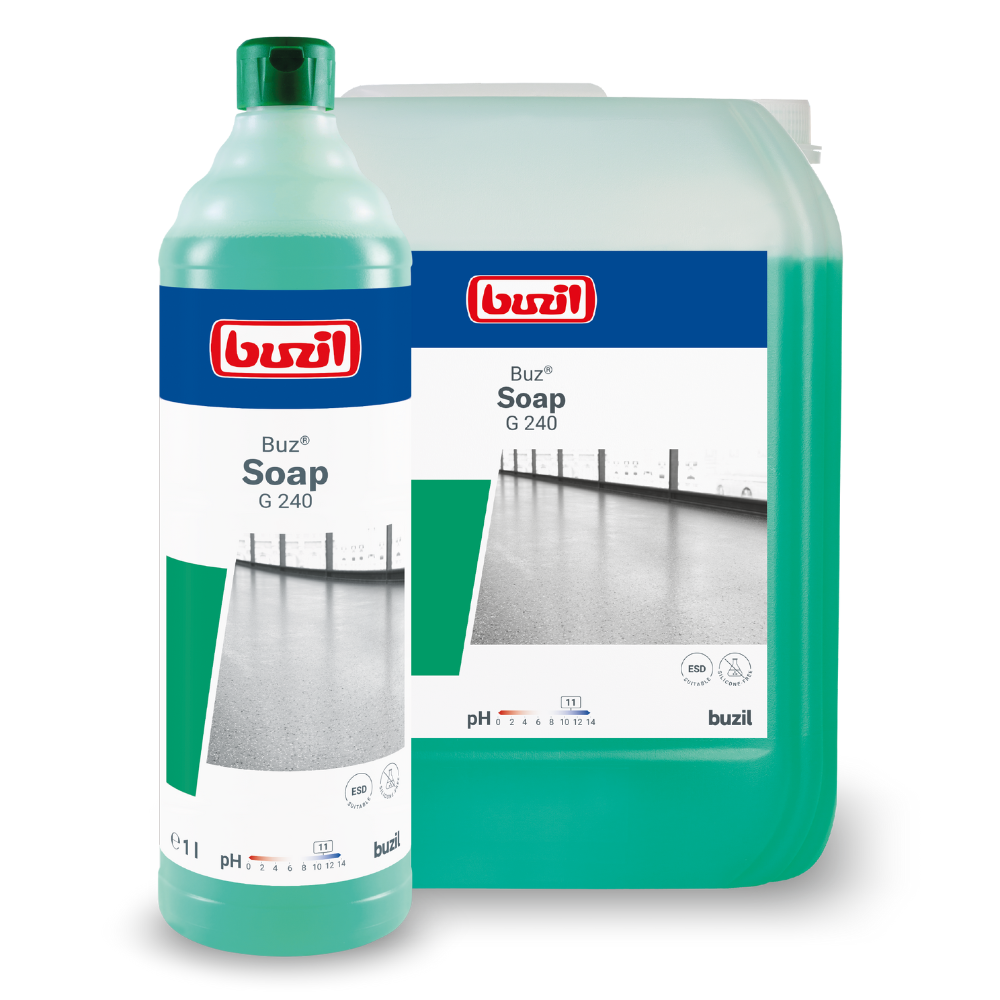Two containers with cleaning agents are shown. In the foreground is a tall bottle with a green liquid labeled "Buzil Buz® Soap G 240 Wiping Care on a Soap Basis, ideal for floor cleaning, by BUZIL-WERK Wagner GmbH & Co. KG". In the background, a larger rectangular container with the same label can be seen. Both containers proudly display the red-blue logo.