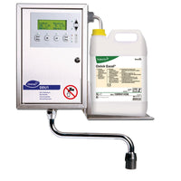 A wall-mounted Diversey DDU1 digital dosing unit for Oxivir Excel 2x5l, featuring a display and buttons, is installed next to a 5-liter Oxivir Excel container, which is held on its tray to ensure precise dosing.