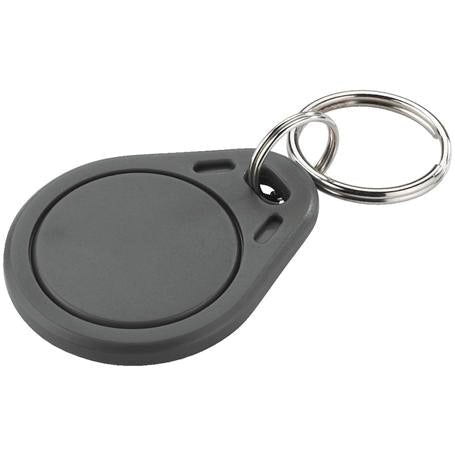 A gray, round Novocal transponder key fob for EZERFID (13.56 MHz MifareClassic), with a metal key ring, depicted on a white background. Pack of 10 pieces (1 piece per unit).