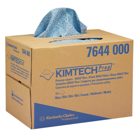 A blue-patterned Kimtech® process wipe is dispensed from a brown Kimberly-Clark GmbH BRAG™ box (1 box x 160 wipes). The box is labeled with product information and is ideal for industrial cleaning.
