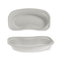Two Meditrade BeeSana® kidney-shaped disposable paper bowls made from paper pulp, shown against a white background—one viewed from above and the other from the side.