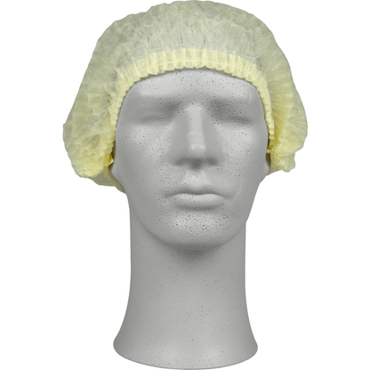 En una cabeza de escaparate gris hay una cofia amarilla clara, PP de Abena Re-Seller GmbH, que ofrece protección higiénica para el ámbito médico o gastronómico. La gorra desechable cubre la parte superior y los lados de la cabeza.
