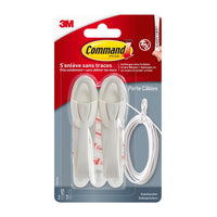 A package of Command™ Cable Clips, 17304-FR, from 3M Deutschland GmbH contains two white cable clips, adhesive strips, and a white cable in a clear plastic package—perfect for minimizing cable clutter and improving cable organization.