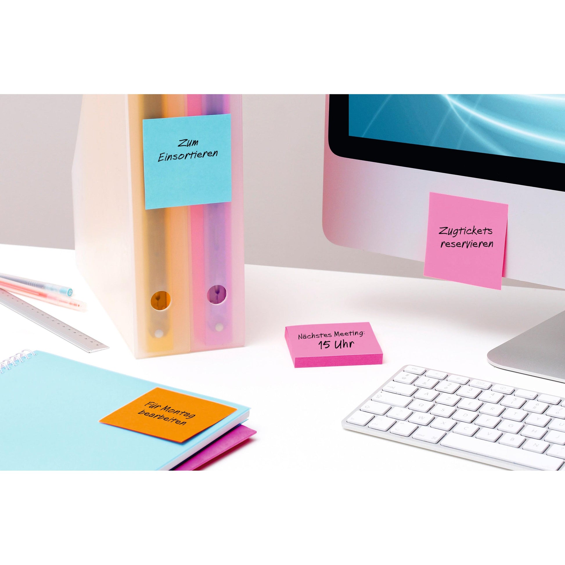 Ein aufgeräumter Schreibtisch mit Ordnern, Monitor, Tastatur, Notizbüchern und einem 3M Deutschland GmbH Post-it® Super Sticky Notes (Gelb, 76x76 mm) mit deutschen Erinnerungshilfen für Meetings und Aufgaben wie Sortieren und Bahnticket buchen.